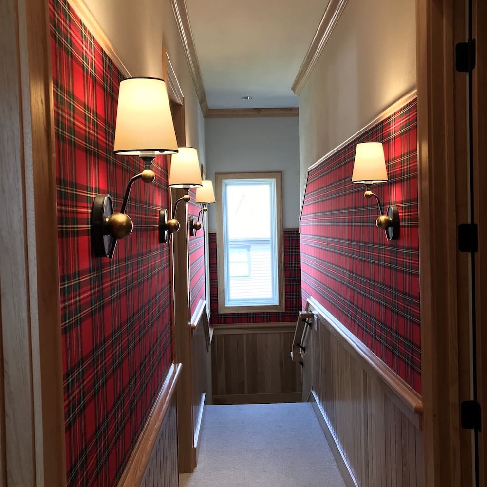 hallway walls in red plaid fabric