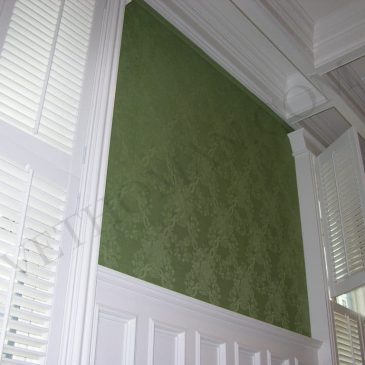 upholstered walls in green damask fabric