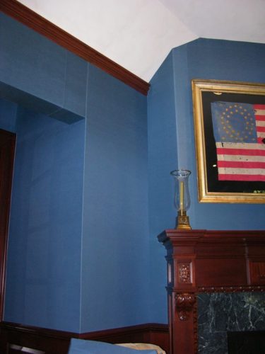 office wall upholstered in a blue taffetas in a home
