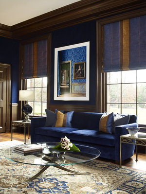 the reading space has a large blue sofa and walls upholstered