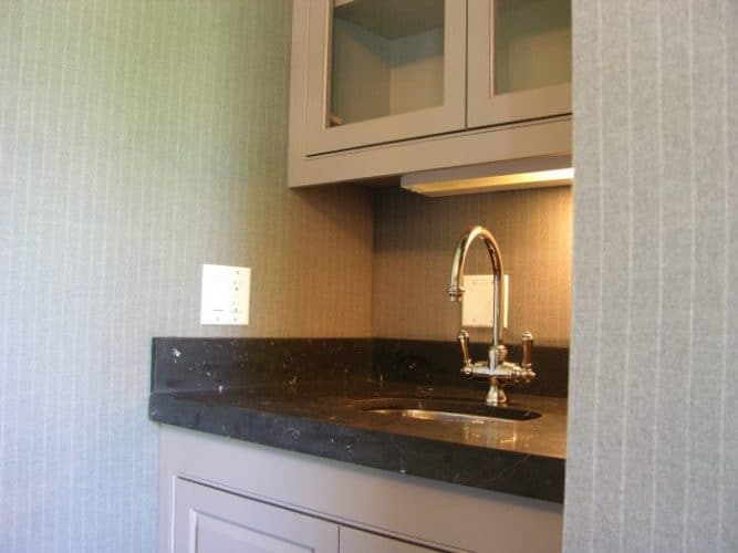 wool fabric upholstered walls around a wet bar