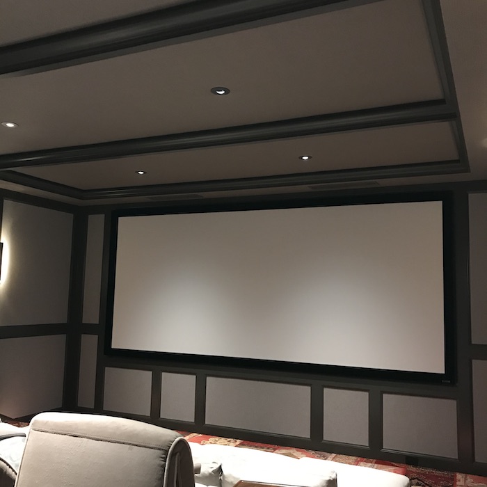 Acoustical home walls | Stretched fabric panels in media room